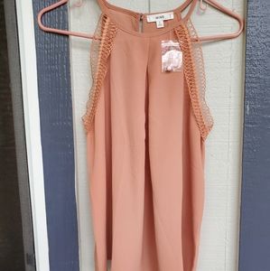 A Peach Sleeveless Blouse.